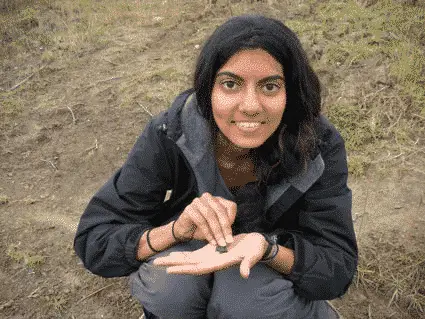 Varsha Vijay with a small frog–the Ecuadorian Amazon has one of the highest numbers of species of amphibians anywhere